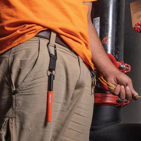 Worker with Skribes Fine Tip Permanent Marker 12 Pack For Worksite And Multi Surface Use Black Ink clipped to belt loop.