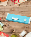 Automatic Needle Threader With Seam Unpicker For Home Sewing Machines Easy Threading Tool For Beginners And Novices No-Fuss Quick Threading Smooth Sewing Sessions Makes Needle Changes Fast And Simple. blue retractable sewing tool on wood table