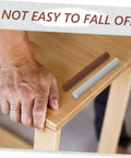 Hand repairing table with Six Pack Wood Repair Wax Filler Sticks For Quick DIY Scratch And Hole Fix On Furniture Tables Doors