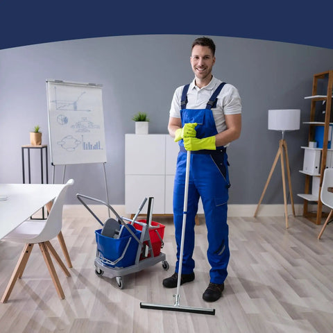 Man holding cleaning tool in office setting, standing near cleaning supplies cart, no visible product details