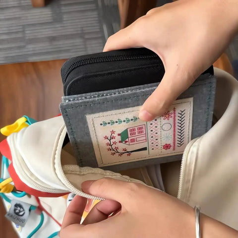 Person placing DIY Embroidery Stitch Book Kit With 106 Illustrated Stitches into a bag, showing portability and easy storage