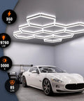 Eight Hexagon Garage Light With 350W 5000K Daylight LED installed on garage ceiling, illuminating a white car below.