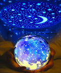 Kids Night Light With Starry Projector Lamp And Universe Glow projecting stars and moon onto ceiling, hands holding glowing globe