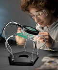 Youth using Helping Hands Soldering Station Workbench Ready Pro Grade With 3X Magnifying Glass And Dimmable LED Flexible 4 Arm Soldering Stand For Welding Repair Hobby DIY Projects Electronics Jewelry And Crafting.