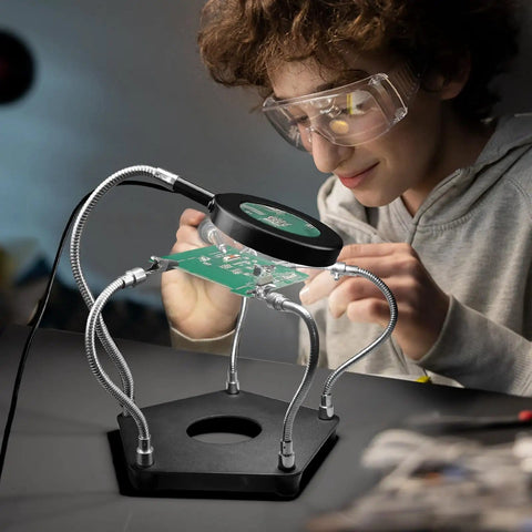 Youth using Helping Hands Soldering Station Workbench Ready Pro Grade With 3X Magnifying Glass And Dimmable LED Flexible 4 Arm Soldering Stand For Welding Repair Hobby DIY Projects Electronics Jewelry And Crafting.