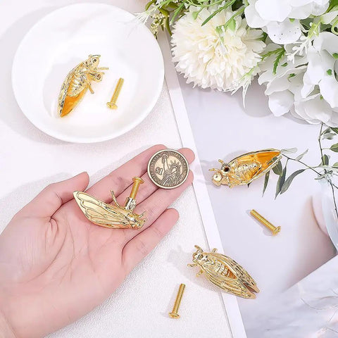 Sweet Cicada Style Golden Brass Cabinet Knobs Four Pack on hand with screws. Heavy duty insect design for kitchen upgrade.
