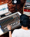 Person using 4 Channel Bluetooth Studio Mixer DJ Controller Interface With USB Recording For PC And Mac XLR Microphone Input