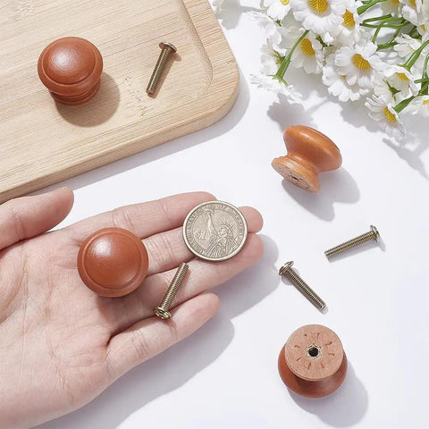Hand holding Mushroom Shaped Wood Drawer Knobs 4 Pack, 28mm 1.1 Inch Brown Cabinet Hardware with screws, coin for scale