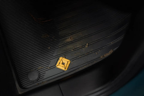 Custom Fit Three Piece All Weather Floor Mats For Rivian R2 With Grippy Antislip Base and dirt on the mat surface.
