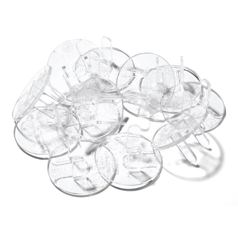 Super Stealthy Child Proof Outlet Covers 12 Pack Ultra Clear Plastic Electrical Safety Plugs stacked together on a white background.