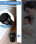 Close-up of black stainless steel cylindrical rubber bumper door stopper in use, protecting the wall and door.