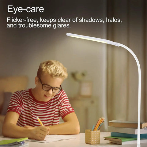 LED Desk Lamp With Clamp For Home Office White USB Port Desk Light Eye Caring Dimmable Task Lamp illuminating a desk for studying.