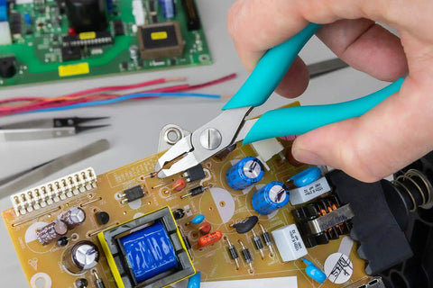 5 Inch Angled Tip Cutter With Ergonomic Co Molded Grip For SMT Lead Trimming, Durable Eremadium Tool Steel, being used on circuit board