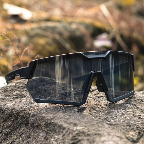 Light Adapting Transition Lenses For Serious Sun Glare Blocking Safety Glasses With Ansi Z87 Certification clear to dark shades on rocky surface.