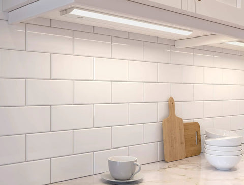 24 Inch LED Under Cabinet Light Bar No Fuss Direct Wire Dimmable and Linkable installed under a kitchen cabinet illuminating countertop