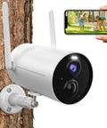 Battery Powered Outdoor Security Camera With Spotlight 1080p HD Color Night Vision Wireless 2 4G WiFi Motion Detection IP65 Weatherproof mounted on tree with smartphone app display.