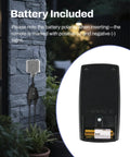 Outdoor Wireless Remote Control Outlet Kit with battery detail and weatherproof power strip installed outside on brick wall.