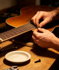 Installing Black M2.5x18.5mm Tuner Peg Screws And Washers For Classical Guitar Machine Heads on an acoustic guitar.