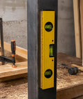 Spirit Level, Aluminum Alloy, 250mm positioned vertically against a dark surface, showcasing its precision features.