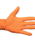Nitrile disposable glove on hand, orange, side view, textured raised diamond grip.