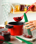 Using 4 Piece Canning Tools Kit with 2 magnetic jar lid lifters and 2 bubble remover measurers in dark green, kitchen scene