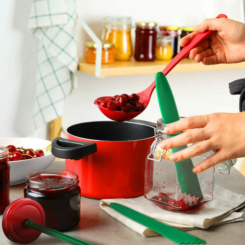 Using 4 Piece Canning Tools Kit with 2 magnetic jar lid lifters and 2 bubble remover measurers in dark green, kitchen scene