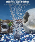 Pawfly aquarium air pump releasing bubbles in a small fish tank with blue and white gravel