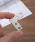 Close-up of Heavy Duty Stainless Steel L Bracket Corner Brace 1.6x1.6 Inch Right Angle Support Connector held in fingers
