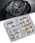 Pro Grade Watch Repair Kit With Stainless Steel Crowns And Gold Flat Head Crowns with spare parts next to a black watch.