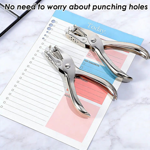 Two Piece Handheld Hole Punch Set With One Quarter Inch And One Eighth Inch Circle Punches on notebook