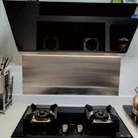 Stainless steel backsplash panel with brushed finish, wall-mounted behind a two-burner gas hob.