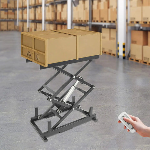 High Tech Electric Scissor Lift Table For Warehouse Pros, 180 Lb Heavy Duty with boxes raised and remote control in hand.