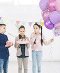 Three children celebrating with a birthday cake and Sixty Eight Piece Pink And Purple Balloons Set 12 Inch Metallic Latex Party Decor.