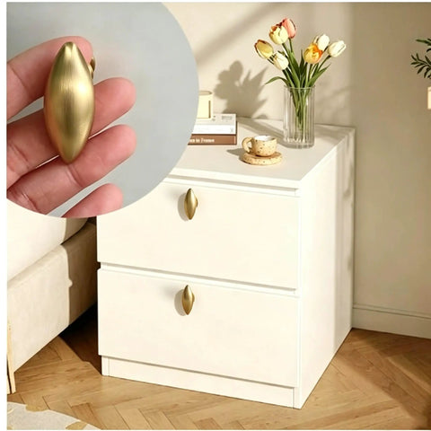 Top Shelf Brushed Brass Oval Cabinet Knobs And Zinc Alloy Single Hole Drawer Pulls Featuring Warm Olive Tones Four Pack shown on drawer.