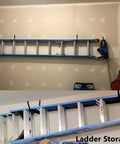 8 Pack Heavy Duty Wall Mounted Ladder Hooks With 12 Inch Jumbo Arm organizing a ladder in garage
