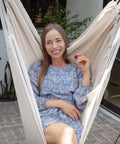 Woman sitting in an XXL hammock chair for big folks with generous 70.9 by 47.2 inches, 500 lb capacity, indoors or outdoors use