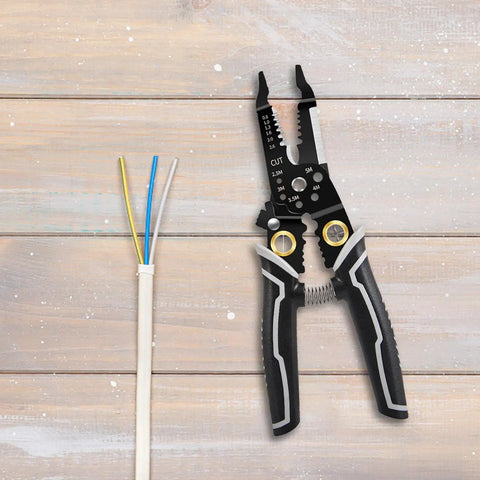 Slick Compact Wire Stripper And Crimping Pliers Featuring Tough Nonslip Grips Plus Rapid Rebound Springs next to stripped wires.