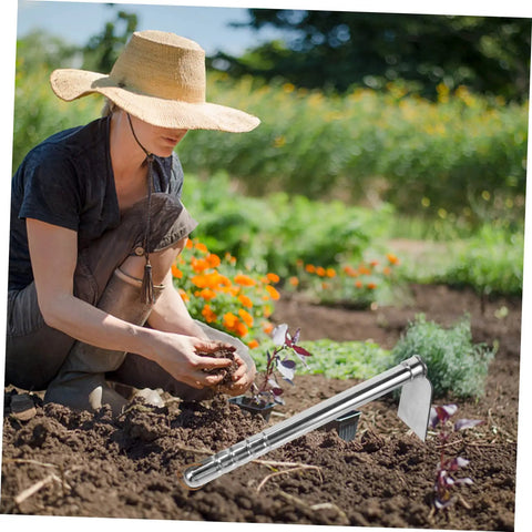 Gardener using Multifunctional Stainless Steel Garden Hoe For Weeding Digging And Cultivating in flower bed.