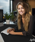 Woman working at desk with Huge 46 By 17 Inch XXL Thick Gaming Mouse Pad For Gamers, black color, under white keyboard.
