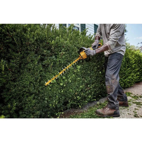 User operating Badass Cordless Hedge Trimmer Equipped With 60 Volt Lithium Battery For Knockout Yard Cleanup on lush bush.