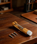Heavy Duty Metal Watch Link Remover Tool With Micro Adjustment Slider showing full view with 3 extra pins on wooden table.