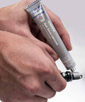 Person applying Anti Seize Lubricant 81343 1 Oz Tube Four Pack With Aluminum Copper And Graphite Blend Salt And Moisture Resistant Marine Grade Formula For No Fuss Spark Plug Removal, Cylinder Head Bolts, And Quick Disassembly to a spark plug.