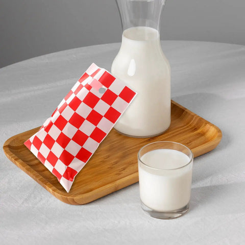 Race Car Themed Gift Bags With Handle Pack Of 50 Portable Lightweight Plastic Candy Bags Checkered Pattern beside milk jug