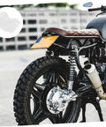 50 Count Elastic Hair Wraps Designed To Keep Your Mane Locked Tight While You Crush Every Shift At The Kitchen Cleanroom Or Facility Breathable Light Fabric Sticks Secure For Zero Fuss Dust Control On The Fly on a motorcycle rear view with brown seat and wheels.