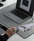 Turn Your Ordinary Laptop Into A Straight Up Gaming Beast With This External GPU Dock next to a laptop on a desk.