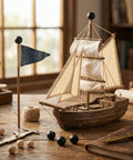 Model ship on a desk with decorative elements, including black knobs resembling 18Pcs M4 x 9mm Threaded Ball Knobs and Screw Caps Set.