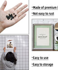 Close-up of 160-piece black metal picture frame hardware set with screws and turn-button fasteners for hanging photos.