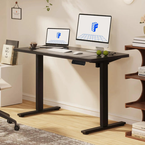 FLEXISPOT Electric Standing Desk With 40x24 Seamless One-Piece Black Desktop set up for dual monitors in stylish home office.
