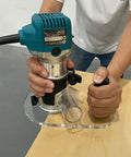 Close-up of Super Slick Clear Acrylic Router Base Plate For RT0701C And XTR01Z in use on a wood surface.