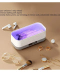 Portable Ultrasonic Cleaner With Rechargeable Battery For Jewelry And Watches One Touch Control showing inside tank with rings and glasses.